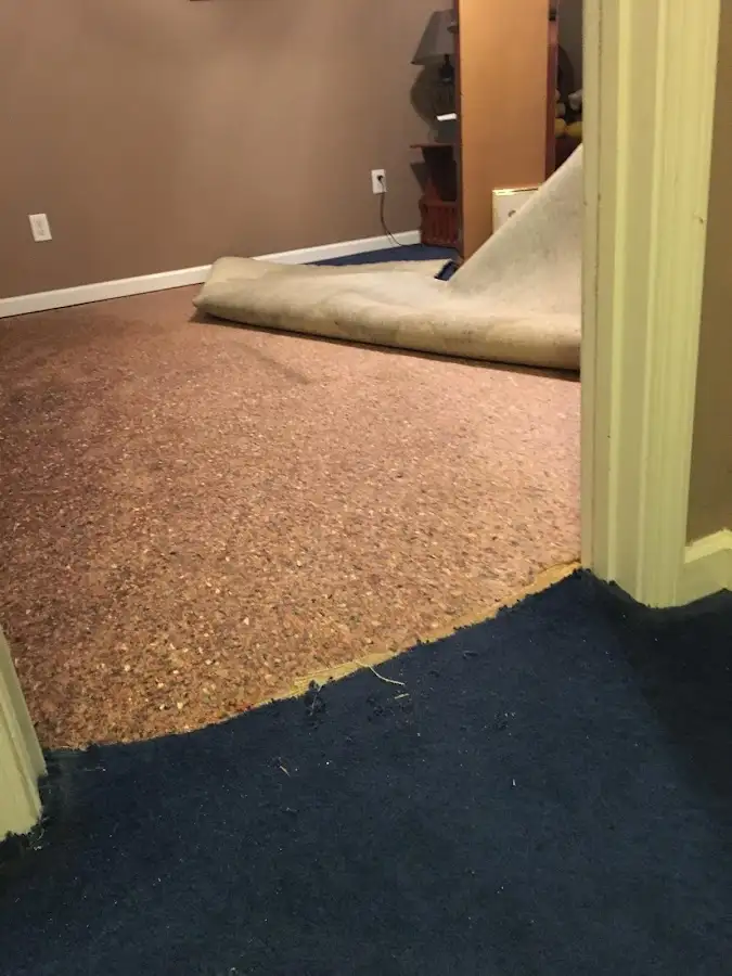 Carpet pad removal revealing water damage during Water Mitigation Services in Lake St. Louis
